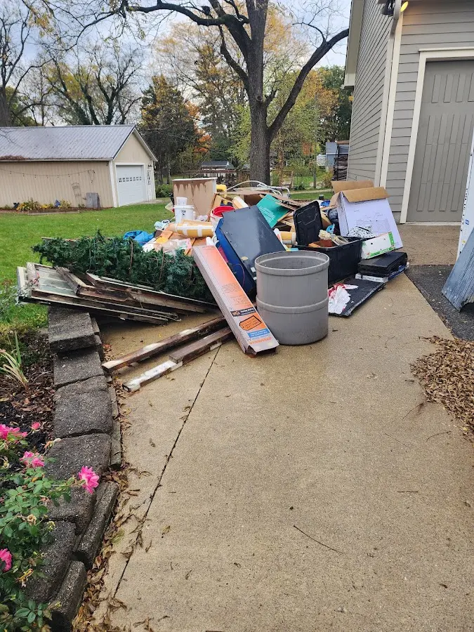 Dumpster being loaded with debris for Commercial Dumpster Rental in Dodgeville